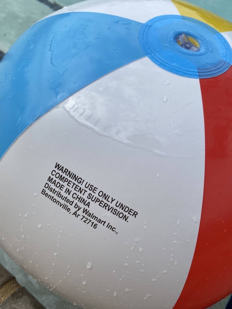 A beach ball with a warning that reads "USE ONLY UNDER COMPETENT SUPERVISION."